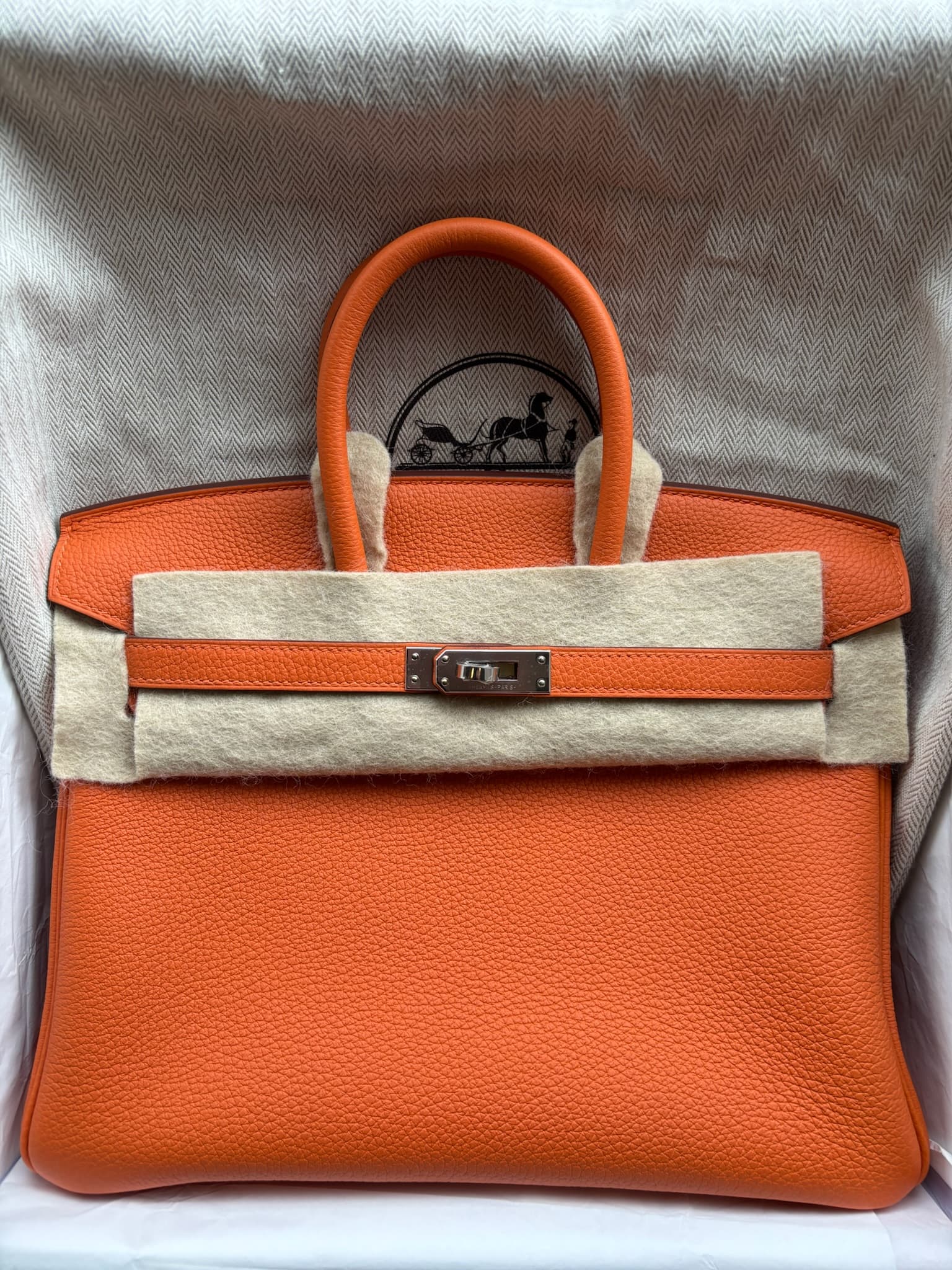 Hermès Birkin 25 in Orange Togo PHW hardware — front view